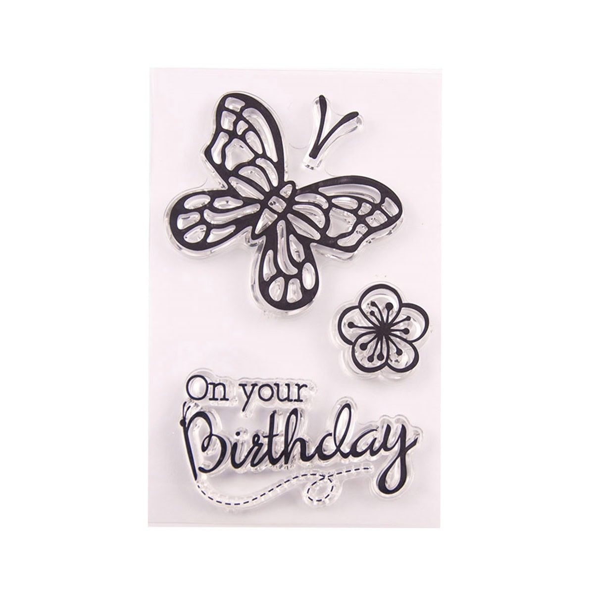 Der "Clear Stamp Schmetterling mit Schriftzug" von Stanzenshop.de zeigt florale Akzente, einen gestanzten Schmetterling und den Spruch "On your Birthday" auf einer transparenten Unterlage.