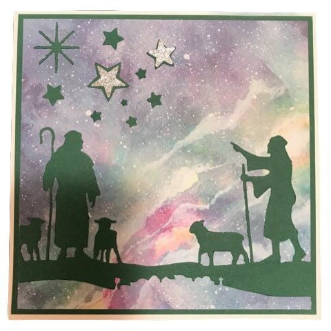 Die Stanzschablone Hirten von Stanzenshop.de zeigt zwei Schäfer mit Schafen vor kosmischem Nachthimmel - ideal für Kartenherstellung oder als Inspiration für Basteln von Wintermotiven.