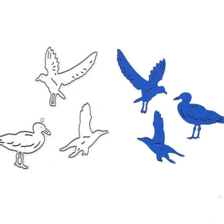 Stanzschablone Drei Möwen von Stanzenshop.de: Blaue Möwen-Silhouetten in unterschiedlichen Posen auf Weiß - ideal als Bastelschablone oder für kreative Scrapbooking-Projekte.