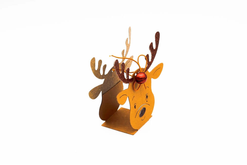 Ein kleines, braunes Papierrentier, gefertigt mit der Stanzschablone: Rentier Aufsteller von Stanzenshop.de und verziert mit einem Geweih und einer roten Nase, steht auf einem weißen Hintergrund.