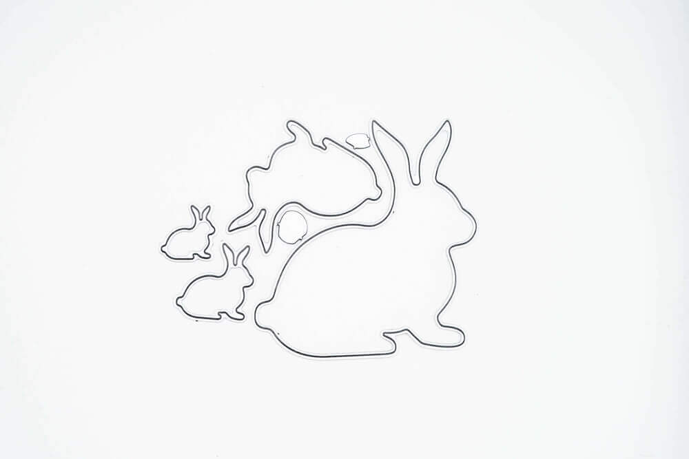 Eine Silhouette eines Hasen und zweier Kaninchen auf weißem Hintergrund, perfekt für Stanzschablone Vier verschiedene Hasen-Projekte von Stanzenshop.de.