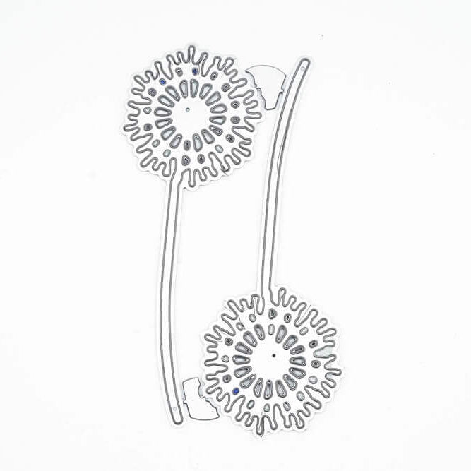 Die "Stanzschablone: Zwei Löwenzahn Pflanzen" von Stanzenshop.de ist eine Metallstanze in Form von zwei Löwenzähnen mit Stängeln, ideal für Scrapbooking oder Basteln. Abgebildet auf einem schlichten weißen Hintergrund.