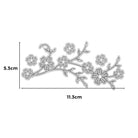 Die "Stanzschablone: Zweig mit mehreren Blüten" von Stanzenshop.de ist eine silberne Metallstanze in Form eines blühenden Zweiges, ideal für Scrapbooking oder Basteln. Sie misst 5,3 cm hoch x 11,3 cm breit, mit beschrifteten Maßen dargestellt.