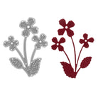 Die "Stanzschablone: Kleine Blume mit drei Blüten" von Stanzenshop.de ist zusammen mit ihrem roten Papier-Ausschnitt abgebildet - ideal zum Basteln oder Scrapbooking.