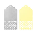 Die Stanzschablone Anhänger mit Verzierung von Stanzenshop.de und ein gelber Anhänger mit Wellenrand und floralem Ausschnitt werden nebeneinander gezeigt - ideal für Scrapbooking oder jedes kreative Bastelergebnis.