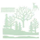 Gestanzte Formen von Bäumen, Rehen, Zaun und Landschaft in zartem Grün von Stanzschablone: Winterwald von Stanzenshop.de schaffen eine heitere Szenerie - ideal für Bastelprojekte oder zum Basteln von Winterlandschaften auf weißem Hintergrund.