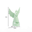 Die Stanzschablone: Engel von Stanzenshop.de ist ein hellgrüner Papier-Engel mit ausgeschnittenen Mustern, ideal für Bastelprojekte oder Scrapbooking. Sie ist 6 cm hoch, an der Basis 4,3 cm breit und 3 cm tief. Abgebildet mit beschrifteten Maßen.