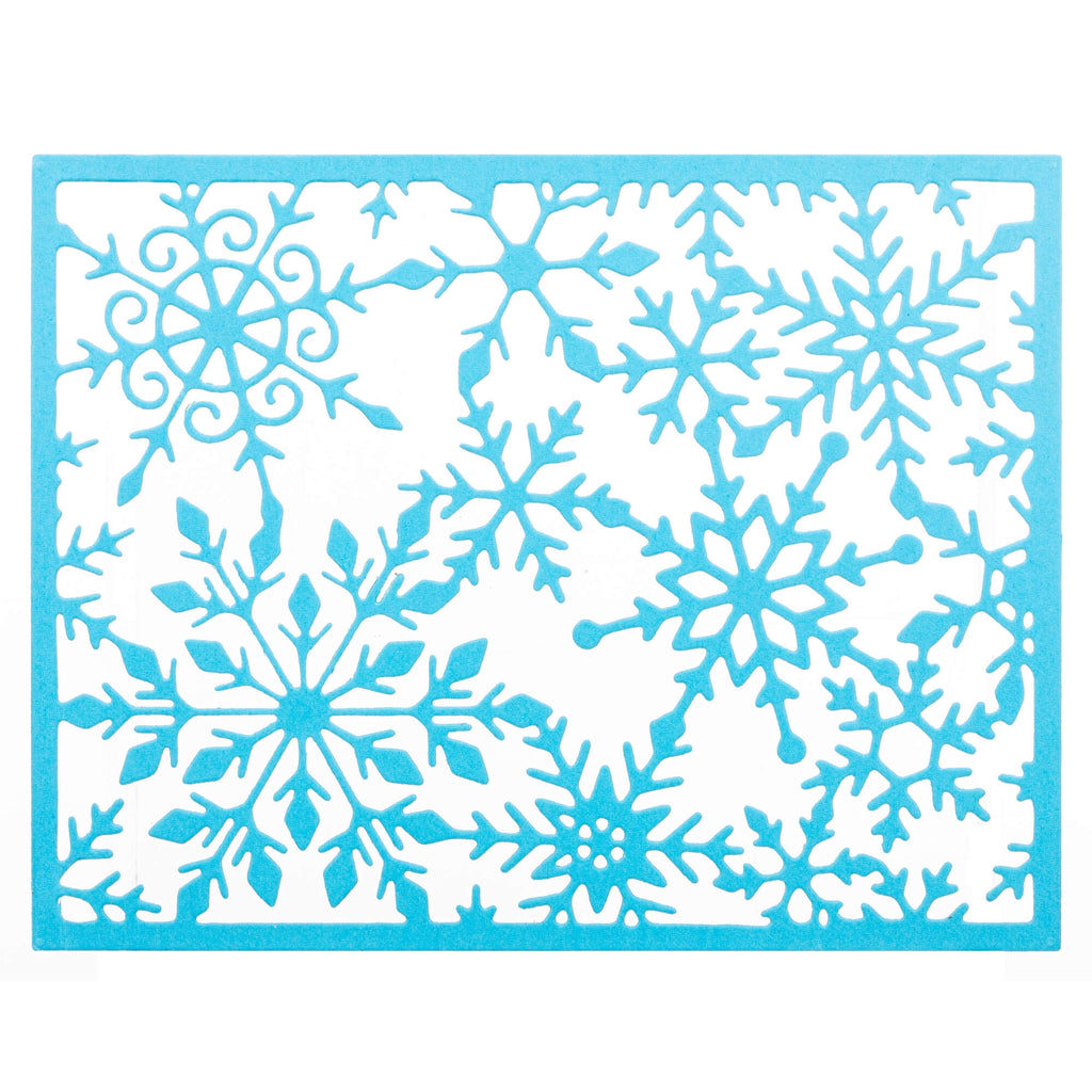 Ein blaues Schneeflockenmuster auf weißem Hintergrund mit einer Stanzschablone: Schneekristalrahmen-Optik von Stanzenshop.de.