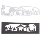 Die Stanzschablone: Krippenausschnitt von Stanzenshop.de und sein schwarzer Papierausschnitt zeigen eine Krippenszene mit Krippe, Heiliger Familie, Weisen und Palmen - ideal zum Basteln von Weihnachtskarten.