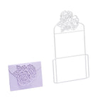 Ein weißer Draht-Organizer mit floralem Muster, gepaart mit einem lila Umschlag, der mit der "Stanzschablone: Umschlag mit Rosen" von Stanzenshop.de, der mit einem charmanten Rosenausschnitt versehen ist.