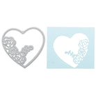 Die Stanzschablone: 3D Herz von Stanzenshop.de aus Metall mit floralen Details liegt neben blauem Papier mit Herz-Cutout - ideal für handgemachte Karten und kreative Bastelideen.