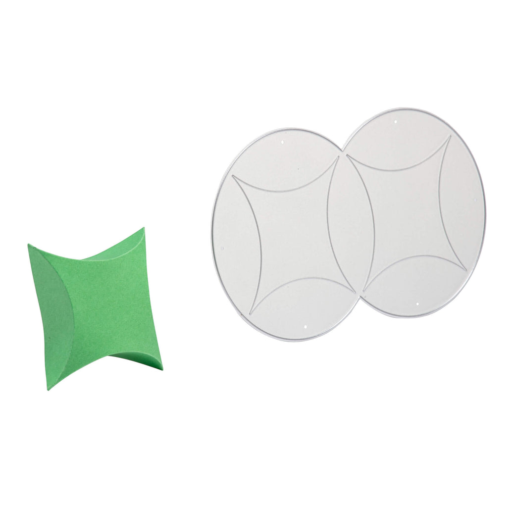 Ein grüner Papier-Origami-Stern neben drei runden transparenten Linsen mit geometrischen Mustern auf einer Kissenschachtel von Stanzenshop.de.