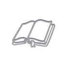 Die Stanzschablone Offenes Buch mit Schleife von Stanzenshop.de, ein offenes Buch in Form eines Metallstempels mit Schleifenmotiv, wird inspiriert vom Buch-Stanze-Design gezeigt und auf weißem Hintergrund fotografiert.