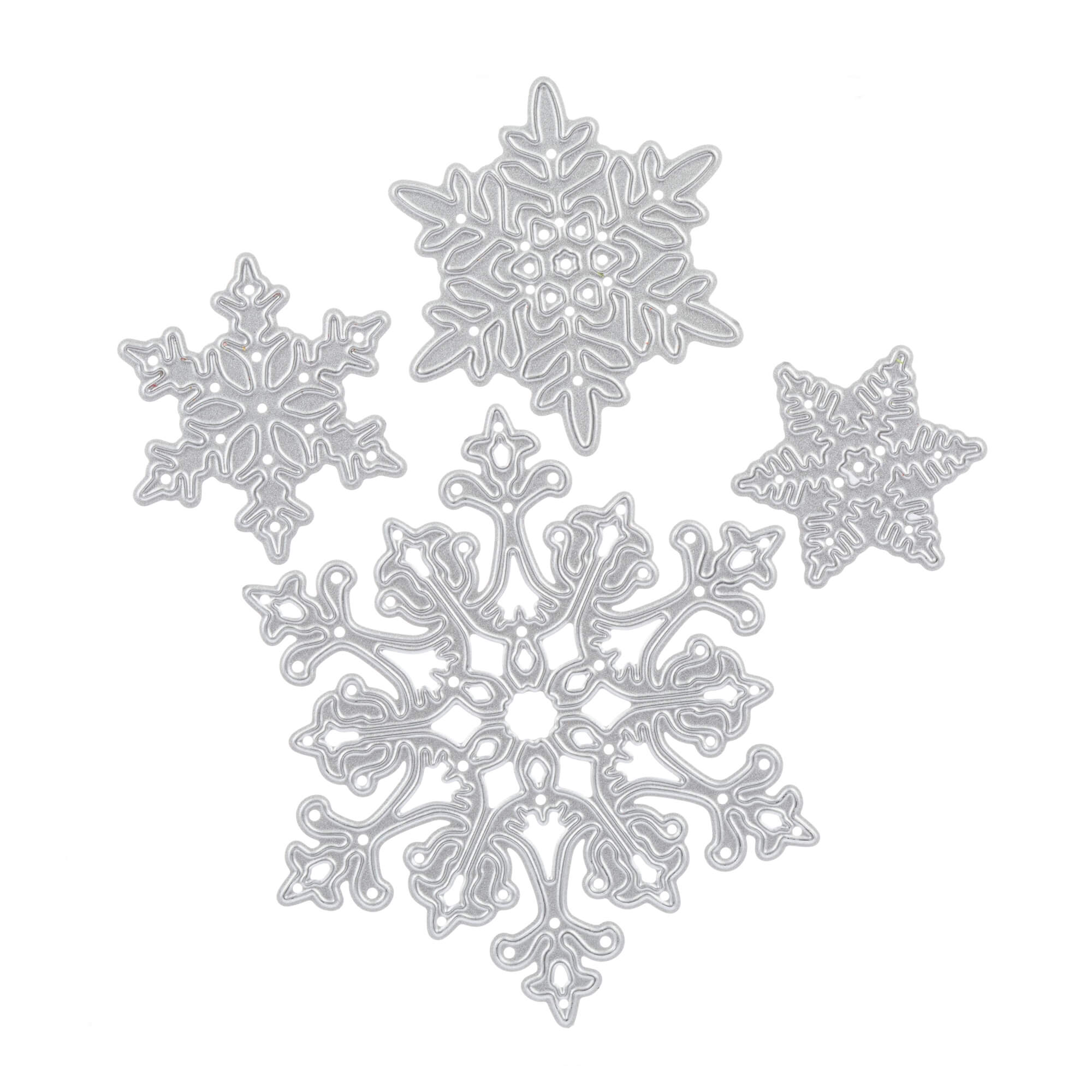 Vier detailreiche silberne Schneeflocken-Ornamente, hergestellt mit der Stanzschablone Vier Schneeflocken in verschiedenen Größen von Stanzenshop.de, sind auf einem weißen Hintergrund angeordnet - ideal für Scrapbooking und Basteln.