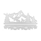 Die Stanzschablone Berge im Schnee von Stanzenshop.de zeigt ein silbernes Stanzmotiv mit Bergen, Bäumen, Hirschen und einer verzierten Umrandung - ideal zum Stanzen von Basteln und zum Veredeln Ihrer Kreationen mit charmanten Wintermotiven.
