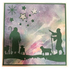 Die Stanzschablone Hirten von Stanzenshop.de zeigt zwei Schäfer mit Schafen vor kosmischem Nachthimmel - ideal für Kartenherstellung oder als Inspiration für Basteln von Wintermotiven.