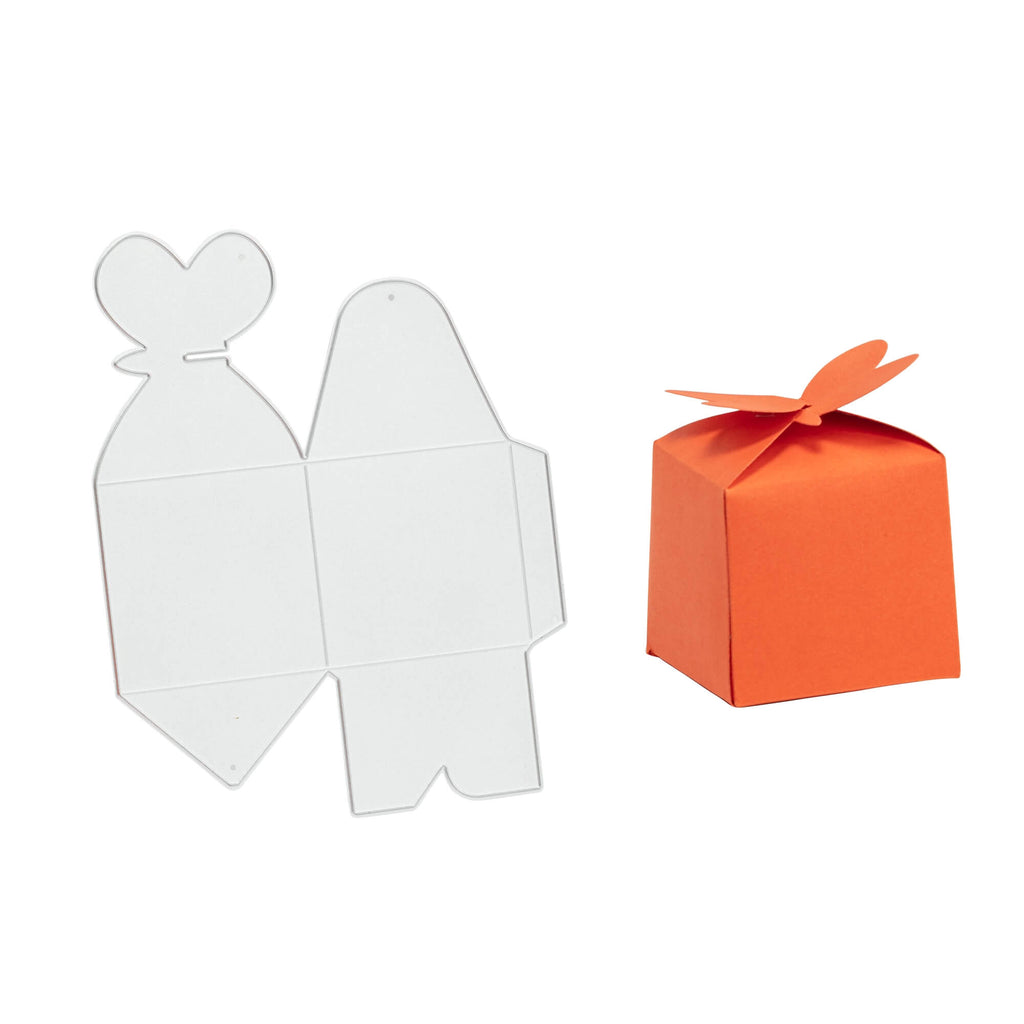 Der Stanzenshop.de bietet günstige Stanzschablonen an, darunter auch die Schachtel mit Schmetterlingsverschluss zum Basteln einer Geschenkbox mit oranger Schleife und weißer Box.