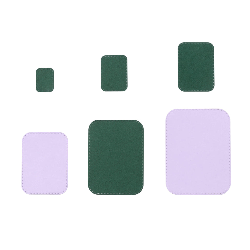 Ein Satz grüner und violetter Quadrate auf weißem Hintergrund, eingerahmt von einer Stanzschablone Sechs Rahmen mit runden Ecken von Stanzenshop.de.