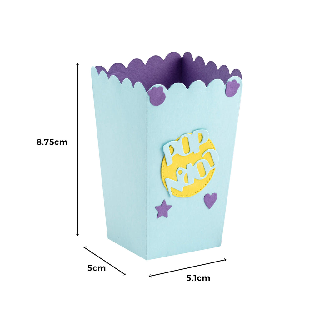 Eine Stanzschablone „Popcornschachtel, Kino, Snack, Behälter“ der Marke Stanzenshop.de mit einem blauen und violetten Design darauf.