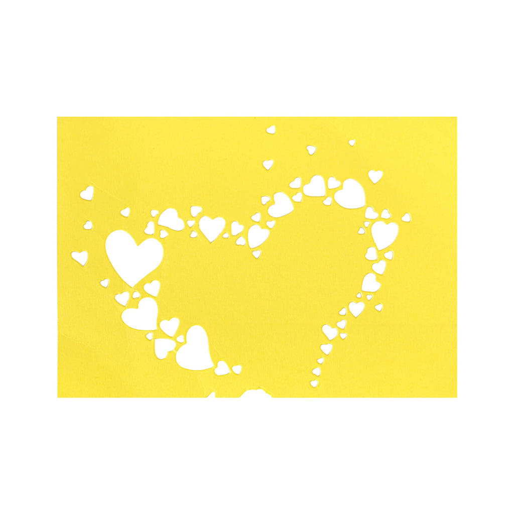 Ein gelber Hintergrund mit weißen Herzen darauf, perfekt für ein Bastelergebnis mit der Stanzschablone Herz aus kleinen Herzen auf Papier von Stanzenshop.de.