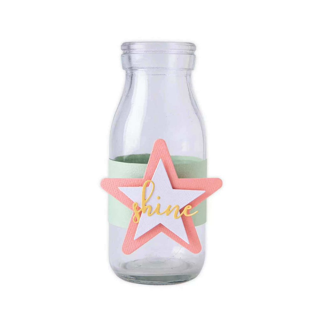 Eine Sizzix-Milchflasche mit einem Stern darauf.