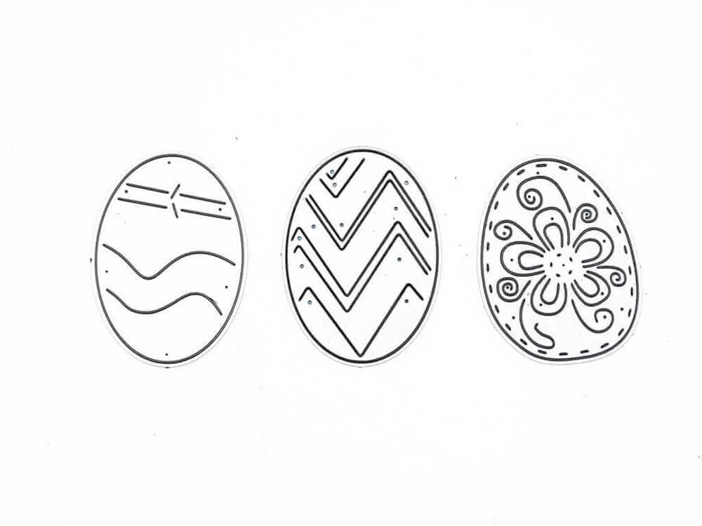 Stanzschablone: Drei Ostereier von Stanzenshop.de zeigt drei Ostereier mit Wellenlinien, Zickzack-Streifen und Blütendesign - ideale Inspiration für Ihre Osterbasteleien!.