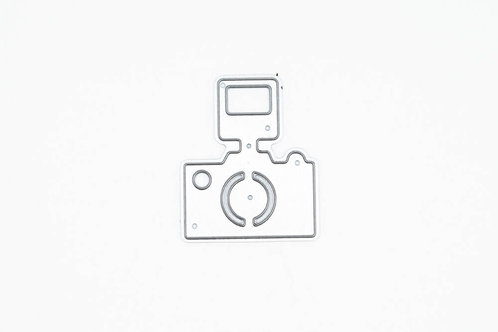 Ein Bild einer Stanzschablone: Kamera mit Blitz von Stanzenshop.de auf einer weißen Fläche.