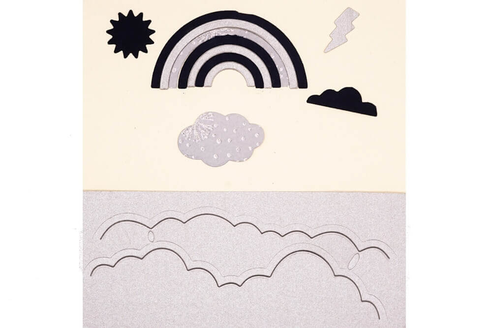 Eine flache Vorlage des Stanzenshop Sets Regenbogen und Wolken von Stanzenshop.de, mit Regenbogen, Sonne, Blitz und Wolken auf einem beigen und silbernen Hintergrund - ideal für Scrapbooking oder zum Kombinieren mit Ihren Lieblingsstanzwerkzeugen.