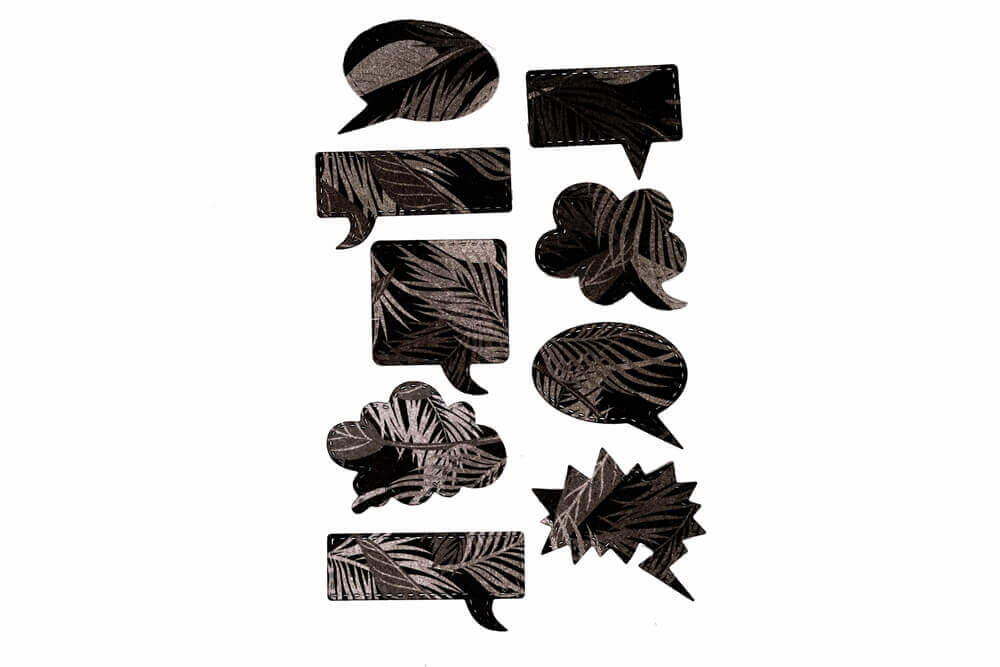 Das Stanzschablone Set mit neun Sprechblasen von Stanzenshop.de bietet schwarze und graue Sprechblasen-Icons mit Blattmustern auf Weiß - ideal für Bastel- und Kreativprojekte.