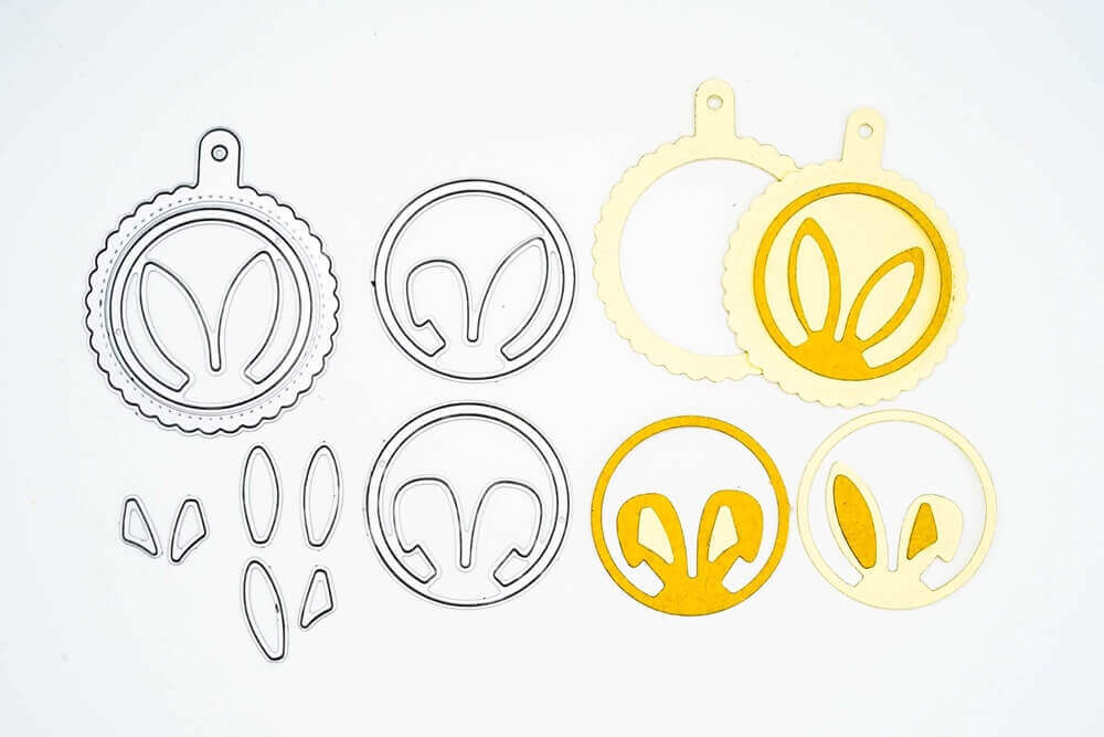 Ein Set Stanzschablone Vier Kreise mit Hasenohren von Stanzenshop.de mit verschiedenen Formen und Farben, geeignet für die Erstellung wunderschöner Kranz-Designs, perfekt für Osterbasteleien.
