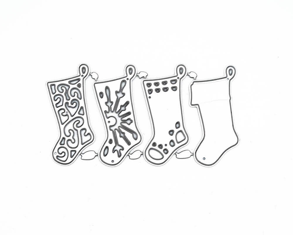 Die "Stanzschablone: Vier Socken" von Stanzenshop.de zeigt vier weihnachtliche Strumpfkonturen - Wirbel, Schneeflocken, Punkte und einfarbig - ideal für Basteln Weihnachten oder Scrapbooking, alle in einer Reihe auf weißem Hintergrund angeordnet.
