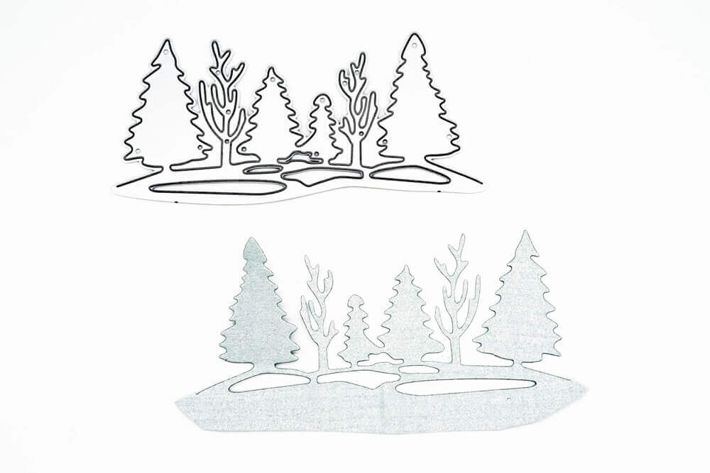 Die "Stanzschablone: Waldlandschaft im Winter" von Stanzenshop.de und der dazugehörige Scherenschnitt, die beide eine winterliche Waldlandschaft zeigen, sind auf weißem Hintergrund zu sehen.