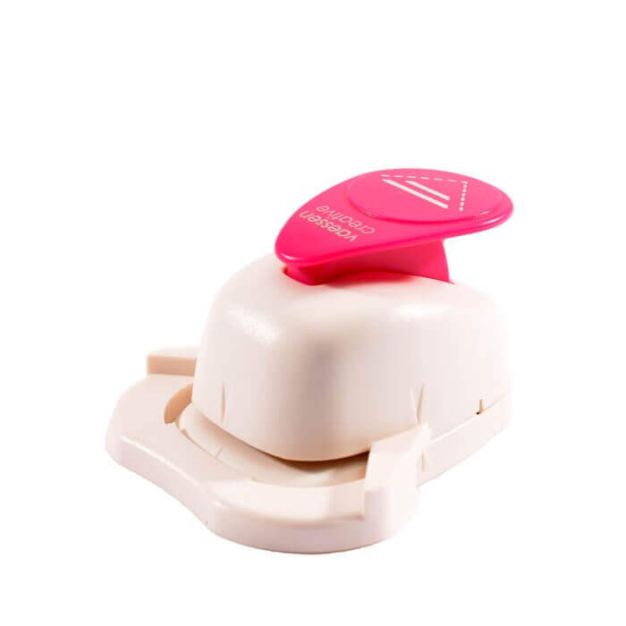 Eine Vaessen Creative-Maschine in Rosa und Weiß mit rosa Griff zum Stanzen.